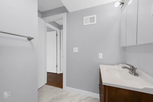 6758 W 64th Pl Unit 13, Chicago, IL 60638 - bathroom with vanity, baseboards, and marble look tiles