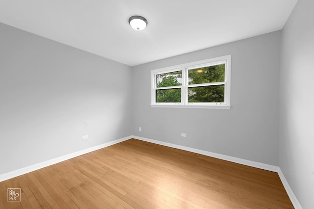 6758 W 64th Pl Unit 13, Chicago, IL 60638 - empty room with hardwood / wood-style floors and baseboards