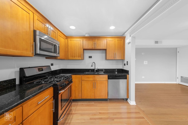 6758 W 64th Pl Unit 13, Chicago, IL 60638 - kitchen featuring appliances with stainless steel finishes, a sink, light wood-style flooring, recessed lighting, and dark stone counters
