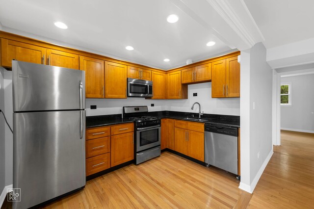 6758 W 64th Pl Unit 13, Chicago, IL 60638 - kitchen with stainless steel appliances, a sink, light wood-type flooring, brown cabinetry, and baseboards