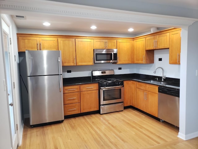 6758 W 64th Pl Unit 13, Chicago, IL 60638 - kitchen with appliances with stainless steel finishes, a sink, light wood finished floors, brown cabinetry, and recessed lighting
