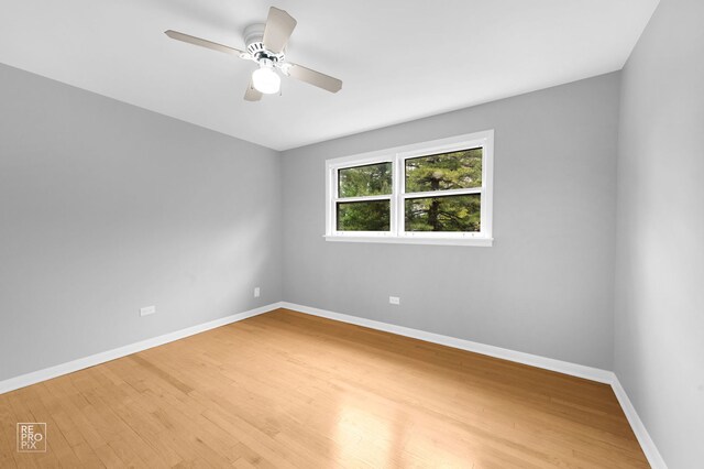 6758 W 64th Pl Unit 13, Chicago, IL 60638 - spare room featuring wood finished floors, baseboards, and ceiling fan