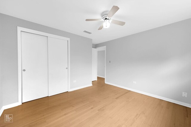 6758 W 64th Pl Unit 13, Chicago, IL 60638 - unfurnished bedroom featuring light wood-type flooring, baseboards, a closet, and a ceiling fan