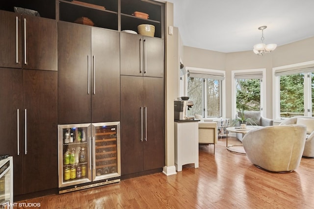 122 Ravine Ln, Barrington, IL 60010 - mudroom featuring wine cooler, light wood-style floors, and a chandelier