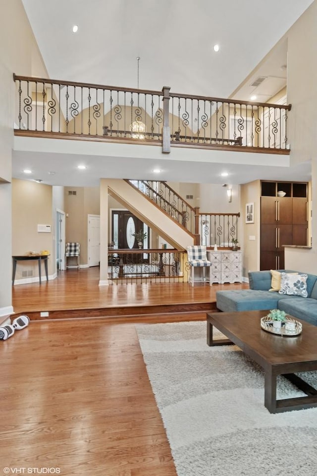 122 Ravine Ln, Barrington, IL 60010 - living area with a towering ceiling, wood finished floors, stairs, and baseboards