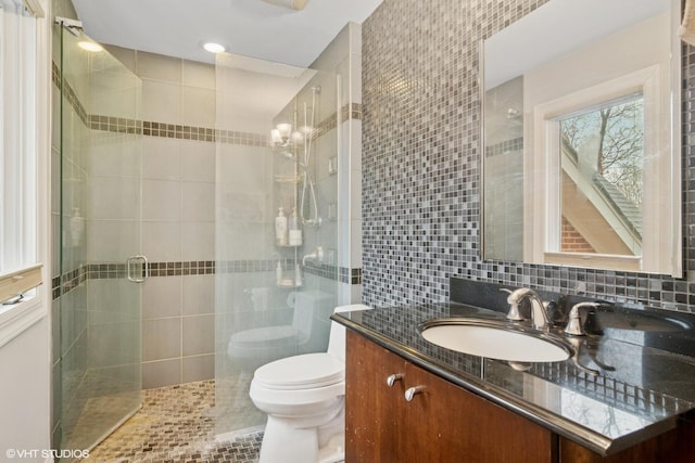122 Ravine Ln, Barrington, IL 60010 - bathroom featuring toilet, a shower stall, vanity, tile walls, and decorative backsplash