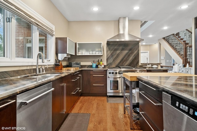 122 Ravine Ln, Barrington, IL 60010 - kitchen featuring appliances with stainless steel finishes, a sink, wall chimney exhaust hood, glass insert cabinets, and light wood-type flooring