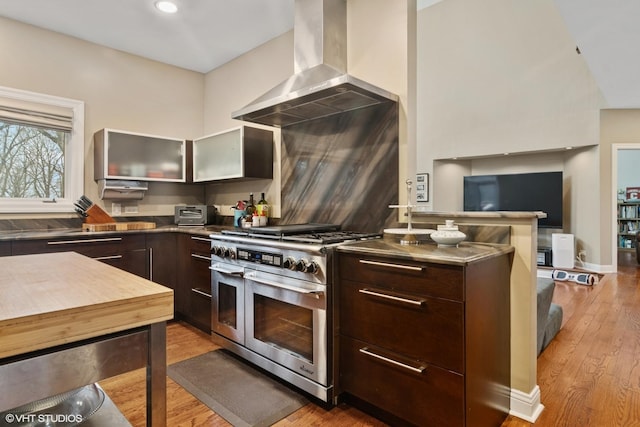 122 Ravine Ln, Barrington, IL 60010 - kitchen featuring double oven range, modern cabinets, wall chimney range hood, dark brown cabinetry, and wood finished floors