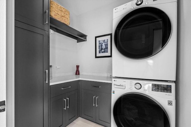 2S384 Madison St, Wheaton, IL 60189 - clothes washing area featuring stacked washing machine and dryer, cabinet space, and light tile patterned flooring