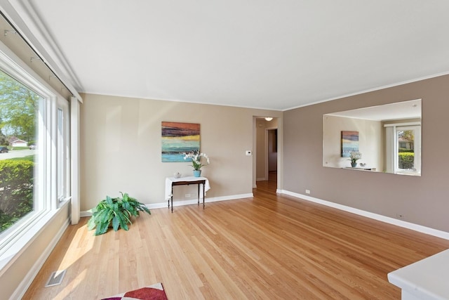6956 Seward St, Niles, IL 60714 - living area featuring healthy amount of natural light, light wood-style floors, baseboards, and ornamental molding