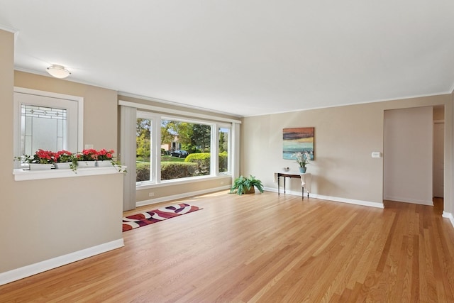 6956 Seward St, Niles, IL 60714 - unfurnished living room featuring baseboards and light wood finished floors