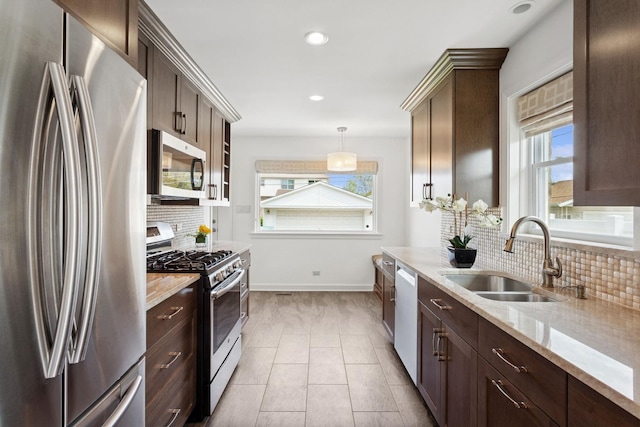 6956 Seward St, Niles, IL 60714 - kitchen with stainless steel appliances, a sink, backsplash, dark brown cabinetry, and baseboards