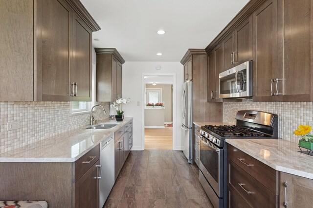 6956 Seward St, Niles, IL 60714 - kitchen featuring stainless steel appliances, a sink, baseboards, dark brown cabinets, and recessed lighting