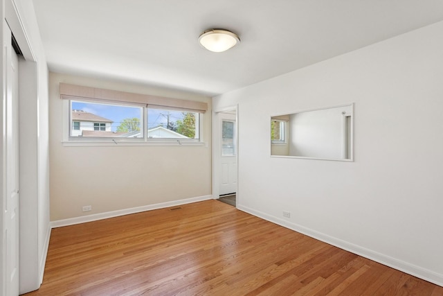 6956 Seward St, Niles, IL 60714 - unfurnished bedroom featuring wood finished floors, baseboards, and a closet