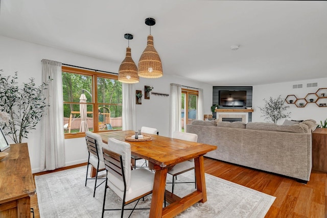 817 W 3rd St, Braidwood, IL 60408 - dining area with plenty of natural light, light wood-style flooring, and a fireplace