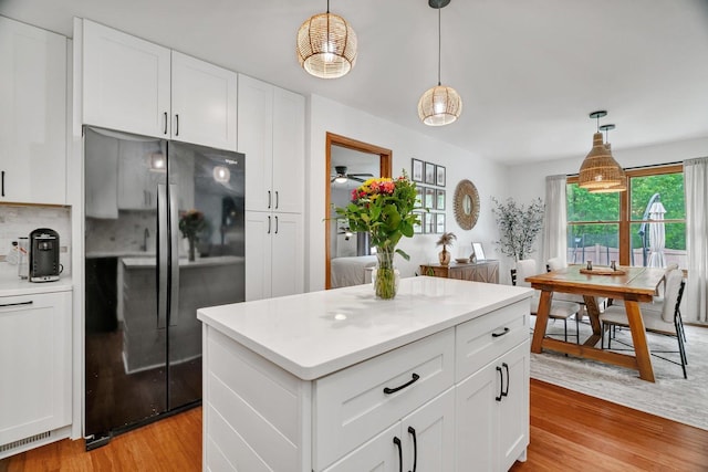 817 W 3rd St, Braidwood, IL 60408 - kitchen with freestanding refrigerator, light wood-style flooring, light countertops, white cabinetry, and pendant lighting