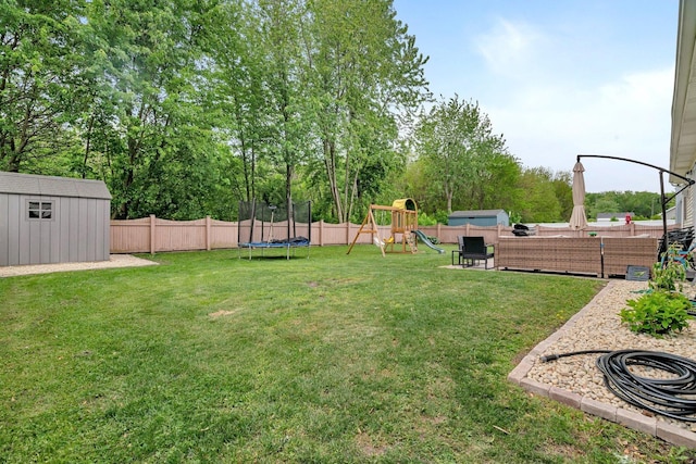 817 W 3rd St, Braidwood, IL 60408 - view of yard with a trampoline, a playground, and view of wooded area