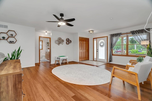 817 W 3rd St, Braidwood, IL 60408 - foyer entrance with baseboards, a ceiling fan, and light wood finished floors