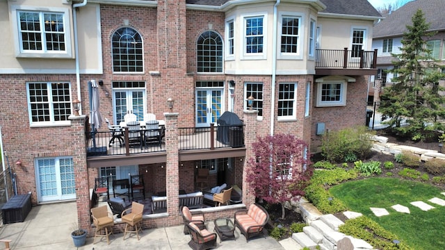 242 Hampshire Ct, New Lenox, IL 60451 - back of property with an outdoor hangout area, stucco siding, a patio area, and brick siding