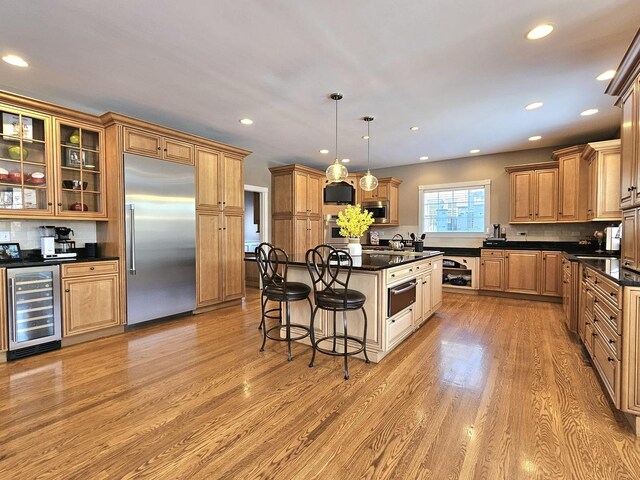 242 Hampshire Ct, New Lenox, IL 60451 - kitchen with built in appliances, beverage cooler, a breakfast bar, a warming drawer, and light wood finished floors