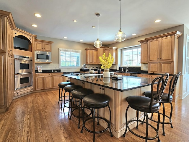 242 Hampshire Ct, New Lenox, IL 60451 - kitchen featuring appliances with stainless steel finishes, plenty of natural light, recessed lighting, a kitchen island, and a breakfast bar area