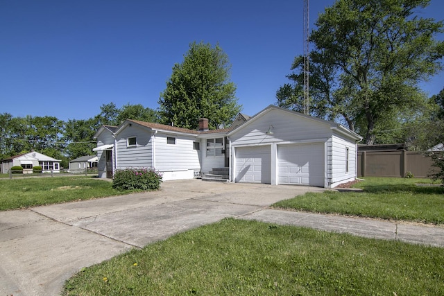 1195 W Williams St, Kankakee, IL 60901 - ranch-style house with a garage, concrete driveway, and a chimney