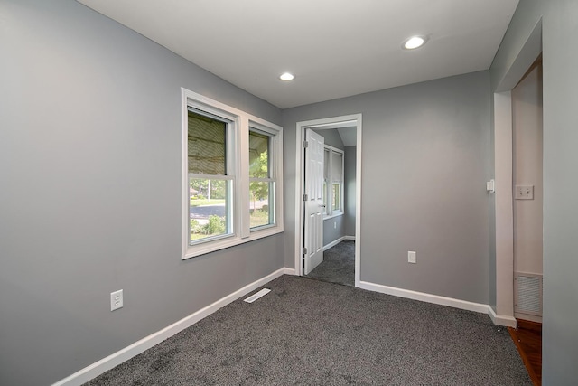 1195 W Williams St, Kankakee, IL 60901 - unfurnished bedroom with baseboards, recessed lighting, and dark colored carpet