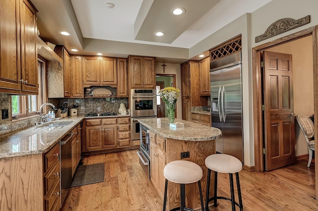 2 Hampton Ct, Burr Ridge, IL 60527 - kitchen featuring built in appliances, a sink, light wood-style floors, a warming drawer, and decorative backsplash