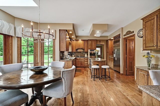 2 Hampton Ct, Burr Ridge, IL 60527 - dining space featuring a chandelier, healthy amount of natural light, and light wood-style flooring