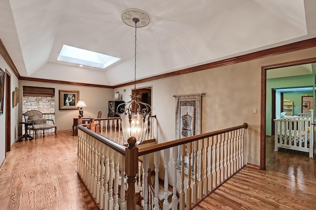 2 Hampton Ct, Burr Ridge, IL 60527 - corridor with an upstairs landing, a skylight, lofted ceiling, a chandelier, and wood finished floors