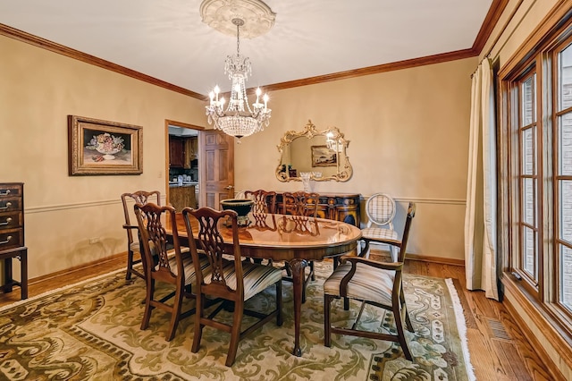 2 Hampton Ct, Burr Ridge, IL 60527 - dining space with plenty of natural light, a chandelier, wood finished floors, baseboards, and crown molding
