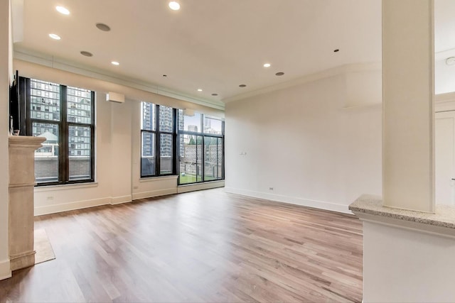 333 W Hubbard St Unit 704, Chicago, IL 60654 - unfurnished living room featuring crown molding, light wood-style floors, baseboards, and recessed lighting