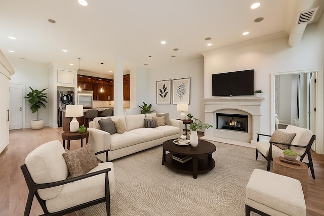 333 W Hubbard St Unit 704, Chicago, IL 60654 - living room featuring light wood finished floors, recessed lighting, and a warm lit fireplace