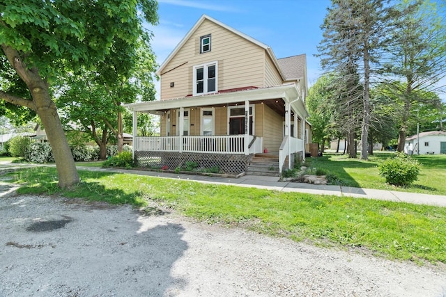 view of front facade with covered porch and a front yard