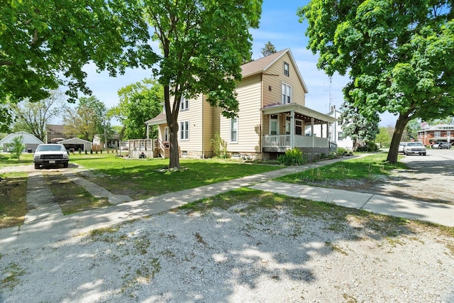 view of front of home with covered porch and a front lawn