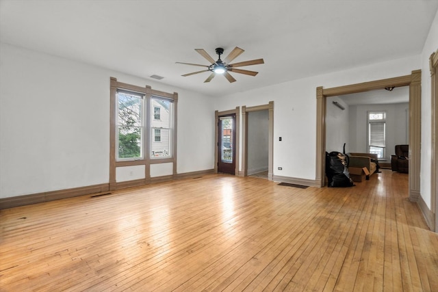 unfurnished living room featuring light wood-style floors, ceiling fan, and baseboards