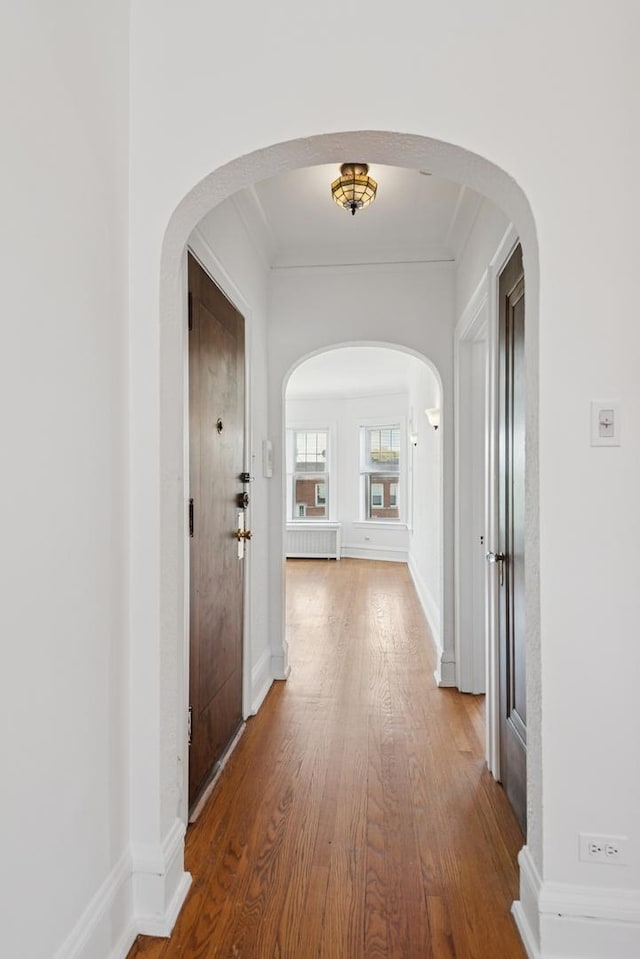 6205 N Oakley St Unit 3, Chicago, IL 60659 - hall with arched walkways, wood finished floors, radiator, ornamental molding, and baseboards
