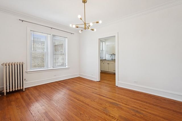 6205 N Oakley St Unit 3, Chicago, IL 60659 - empty room with radiator, a chandelier, light wood-style flooring, ornamental molding, and baseboards