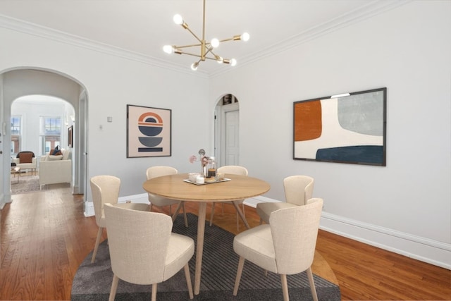 6205 N Oakley St Unit 3, Chicago, IL 60659 - dining space with arched walkways, wood finished floors, crown molding, baseboards, and a chandelier