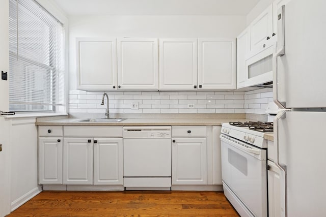6205 N Oakley St Unit 3, Chicago, IL 60659 - kitchen with white appliances, a sink, white cabinetry, decorative backsplash, and light countertops