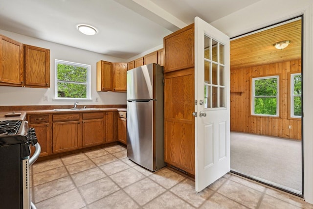 28549 W High Rd, Ingleside, IL 60041 - kitchen with stainless steel appliances, a sink, brown cabinetry, and wooden walls