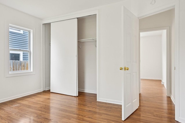 28549 W High Rd, Ingleside, IL 60041 - unfurnished bedroom with wood finished floors, a closet, and baseboards