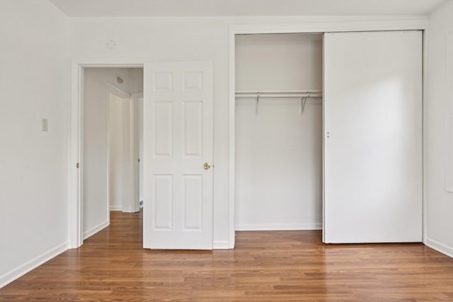 28549 W High Rd, Ingleside, IL 60041 - unfurnished bedroom with wood finished floors, a closet, and baseboards