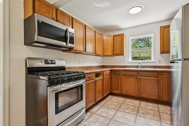28549 W High Rd, Ingleside, IL 60041 - kitchen featuring stainless steel appliances, a sink, and brown cabinetry