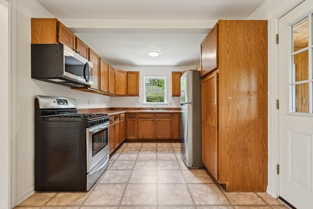 28549 W High Rd, Ingleside, IL 60041 - kitchen with appliances with stainless steel finishes, a sink, and brown cabinets