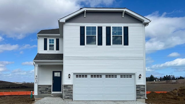 5010 Linden Rd, Mount Pleasant, WI 53403 - view of front of house with stone siding, a garage, a shingled roof, driveway, and fence