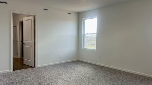 5010 Linden Rd, Mount Pleasant, WI 53403 - spare room featuring dark carpet, plenty of natural light, and baseboards