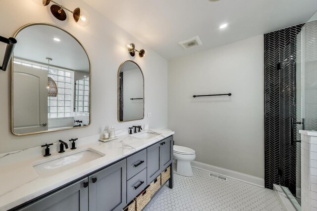 3506 N Southport Ave Unit 1N, Chicago, IL 60657 - bathroom featuring double vanity, tiled shower, toilet, and baseboards