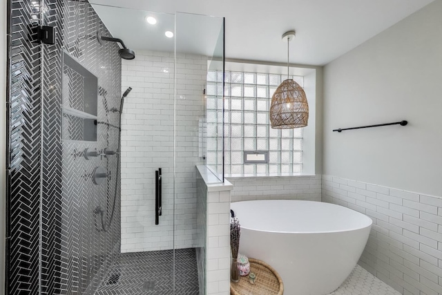 3506 N Southport Ave Unit 1N, Chicago, IL 60657 - bathroom featuring tile walls, a freestanding bath, a wainscoted wall, a shower stall, and recessed lighting