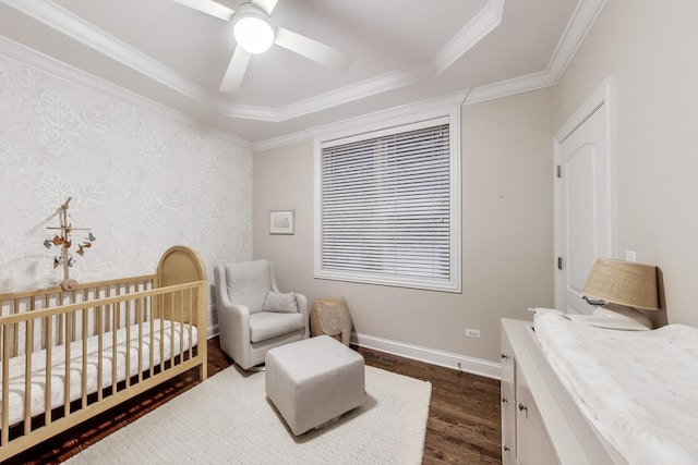 3506 N Southport Ave Unit 1N, Chicago, IL 60657 - bedroom with dark wood-type flooring, crown molding, baseboards, a crib, and a tray ceiling